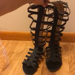 Black below the knee gladiator sandals.